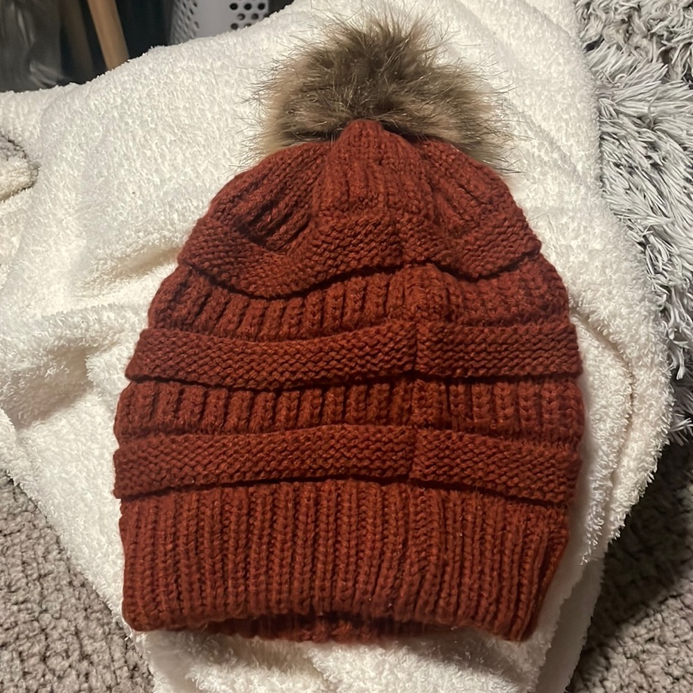 Burnt orange knitted hat with puff